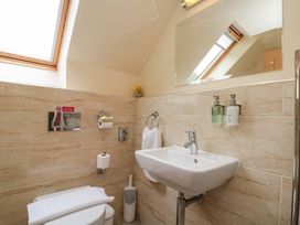 A bathroom with sink and shower at Clematis Cottage in Whitby