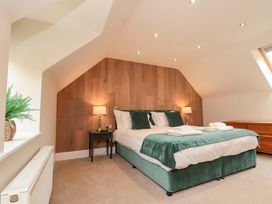 A bedroom with a bed and bedside table at Clematis Cottage in Whitby