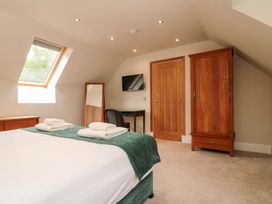 A bedroom with a bed and television at Clematis Cottage in Whitby