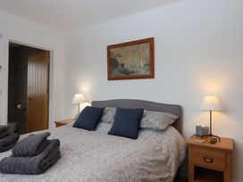 A bedroom with a bed and bedside table at Lower Moorwood Moorwood near Bovey Tracey