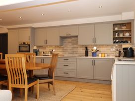 A kitchen with a dining table and various appliances at Lower Moorwood in Moorwood near Bovey Tracey