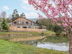 A house with a pond surrounded by trees at Lower Moorwood in Moorwood near Bovey Tracey