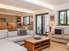 A living room with a sofa and coffee table at Lower Moorwood near Bovey Tracey