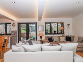 A living room with a sofa and armchair at Lower Moorwood near Bovey Tracey