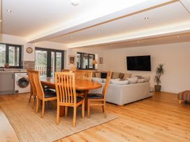 An open plan living area with a dining table and sofa at Lower Moorwood in Moorwood near Bovey Tracey