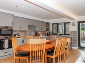 A kitchen with a dining table and chairs at Lower Moorwood Moorwood near Bovey Tracey