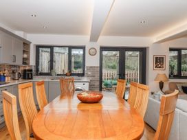 A kitchen with a dining table and chairs at Lower Moorwood in Moorwood near Bovey Tracey