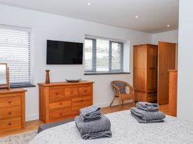 A bedroom with a television and dresser at Lower Moorwood in Moorwood near Bovey Tracey