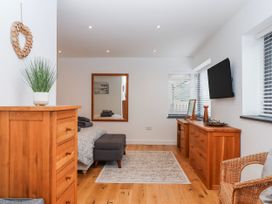 A bedroom with a bed and wooden furniture at Lower Moorwood in Moorwood near Bovey Tracey
