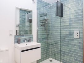 A bathroom with a shower and sink at Lower Moorwood, Moorwood near Bovey Tracey