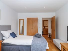 A bedroom with a bed and wardrobe at Lower Moorwood in Moorwood near Bovey Tracey