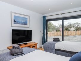 A bedroom with two beds and a television at Lower Moorwood in Moorwood near Bovey Tracey