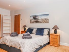 A bedroom with a bed and bedside tables at Lower Moorwood in Moorwood near Bovey Tracey