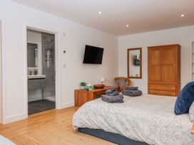 A bedroom with a bed and wardrobe at Lower Moorwood near Bovey Tracey