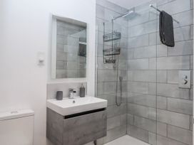 A bathroom with a shower and sink at Lower Moorwood in Moorwood near Bovey Tracey