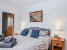 A bedroom with a bed and nightstand at Lower Moorwood in Moorwood near Bovey Tracey