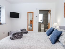 A bedroom with a bed and towels at Lower Moorwood in Moorwood near Bovey Tracey