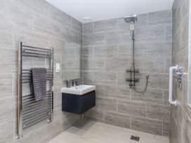 A bathroom with a shower and sink at Lower Moorwood in Moorwood near Bovey Tracey