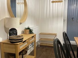An entryway with a console table and mirror at Plas Darien Apartment 7 Trearddur Bay