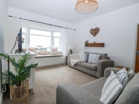 A living room with a television and sofa at No.7 Plas Darien Trearddur Bay