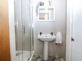 A bathroom with a shower and sink at No.7 Plas Darien Trearddur Bay