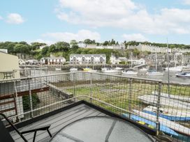 A view of boats on water from a balcony at Harbwr Hideaway in Porthmadog