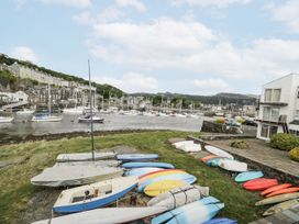 A view of boats by the water and buildings in Porthmadog