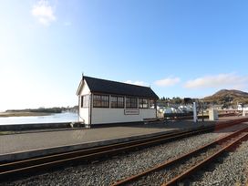 A signal box at a train station near a river at Harbwr Hideaway in Porthmadog