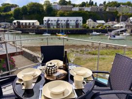 An outdoor dining area with a table set for tea at Harbwr Hideaway in Porthmadog