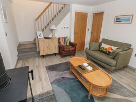 A living room with a coffee table and sofa at Folly Cottage Llanteg near Saundersfoot