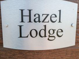 A sign with the name Hazel Lodge