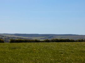A view of fields and hills under a clear sky at Juniper Lodge in Whitby