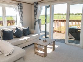 A living room with a sofa and coffee table at Magnolia Lodge in Whitby