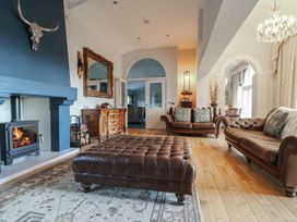 A living room with a fireplace and sofas at The Colonnade in Trefnant