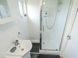 A bathroom with a sink and a shower enclosure at 68 Cherry Park Chapel St Leonards