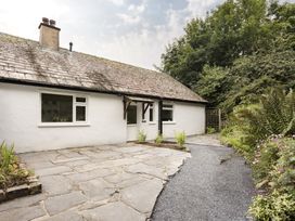 An exterior view of a house with a path and garden at Tethers End in Lindeth near Bowness-On-Windermere