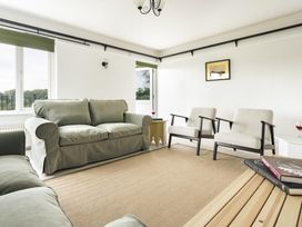A living room with a sofa and armchairs at Tethers End in Lindeth near Bowness-On-Windermere