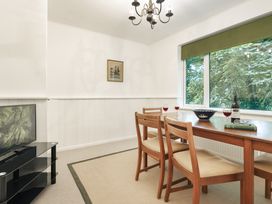 A dining room with a table and chairs at Tethers End in Lindeth near Bowness-On-Windermere
