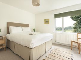 A bedroom with a bed and nightstand at Tethers End in Lindeth near Bowness-On-Windermere