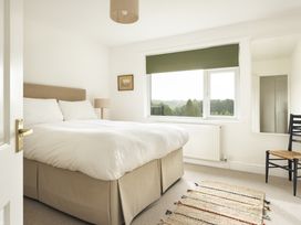 A bedroom with a bed and a window at Tethers End in Lindeth near Bowness-On-Windermere
