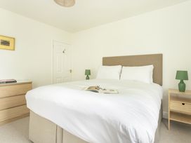 A bedroom with a bed and nightstand at Tethers End in Lindeth near Bowness-On-Windermere