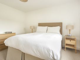 A bedroom with a bed and bedside tables at Tethers End in Lindeth near Bowness-On-Windermere