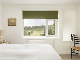 A bedroom with a window and a bed at Tethers End in Lindeth near Bowness-On-Windermere