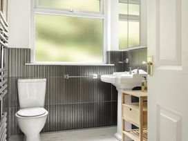 A bathroom with a toilet and sink at Tethers End in Lindeth near Bowness-On-Windermere