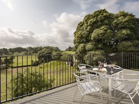 An outdoor patio with table and chairs at Tethers End in Lindeth near Bowness-On-Windermere