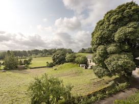 A view of a field and trees at Tethers End in Lindeth near Bowness-On-Windermere