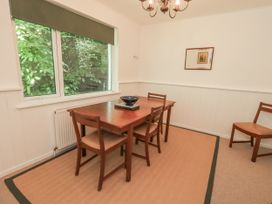 A dining room with a table and chairs at Tethers End in Lindeth near Bowness-On-Windermere