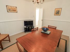 A dining room with a table and chairs at Tethers End in Lindeth near Bowness-On-Windermere