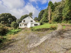 A house with a driveway and garden at Tethers End in Lindeth near Bowness-On-Windermere