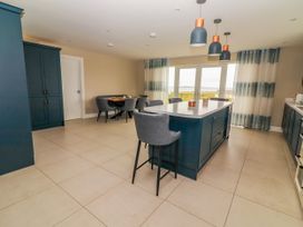 A kitchen with a dining table and chairs at Carrowmore North, Doonbeg, County Clare